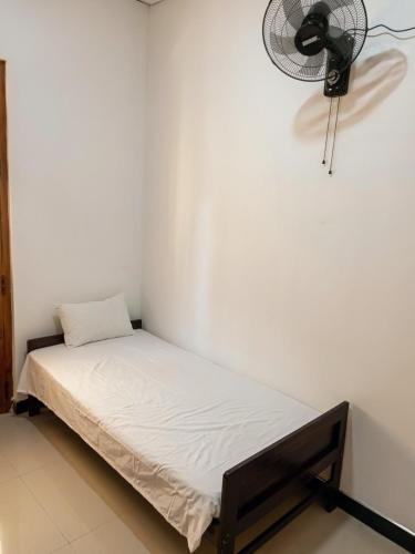 a small bed in a room with a fan at kuma holiday resort in Meda-Ela