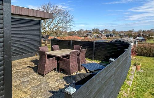 a patio with a table and chairs and a fence at 2 Bedroom Stunning Home In Roslev in Roslev