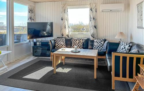 a living room with a couch and a table at 2 Bedroom Stunning Home In Roslev in Roslev