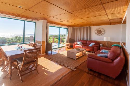 a living room with a couch and a table at White Waves on the Beach in Hastings Point