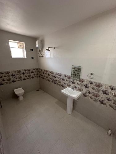 a bathroom with a sink and a toilet at Goa Paradise House in Canacona