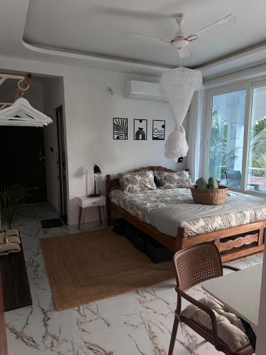 a bedroom with a large bed and a window at Goa Paradise House in Canacona