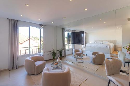 a bedroom with a bed and a large mirror at Le Semiramis l Central & Views l Shellter Rentals in Saint-Tropez