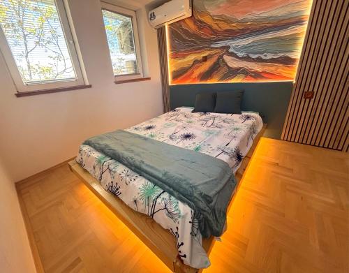 a bed in a room with a painting on the wall at Puro Center in Ohrid