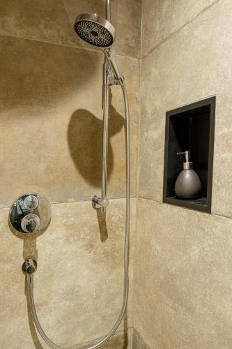 a shower with a shower head in a bathroom at Elsers Nummer12 in Weilheim an der Teck