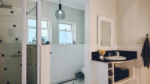 a bathroom with a sink and a toilet at Authentic Mossel Bay in Mossel Bay