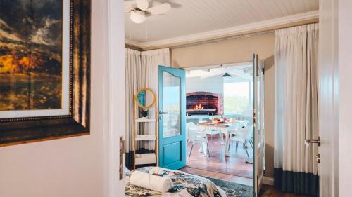 a room with a table and a dining room at Authentic Mossel Bay in Mossel Bay