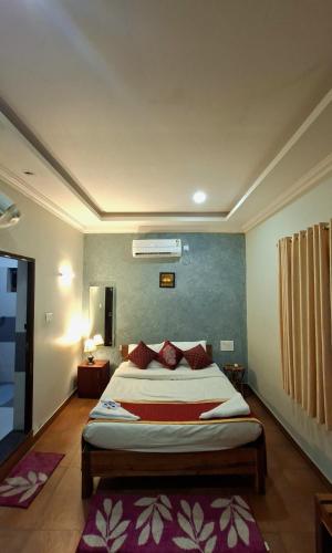 a bedroom with a large bed in a room at Karapuzha Water Scapes Wayanad in Wayanad