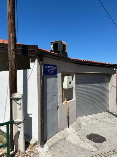a building with a garage with a sign on it at Apartman Biser in Sarajevo