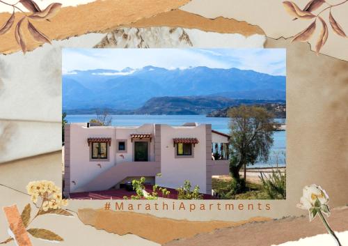 a picture of a house with mountains in the background at Marathi Apartments in Marathi