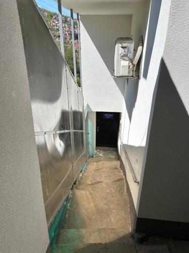 an empty hallway in a building with a tunnel at Apartman Biser in Sarajevo