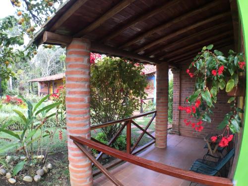 a porch with a brick building with a roof at Cabañas La Carolina - Mesa de Los Santos in Los Santos