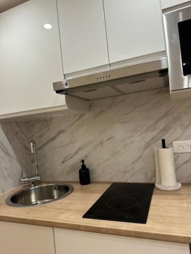 a kitchen with a sink and a counter top at Studio design in Beaune