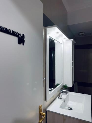 a bathroom with a sink and a mirror at Ioanian Évasion in Vlorë