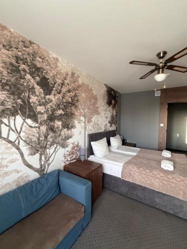 a bedroom with a bed and a couch at Villa Rafa in Mielno