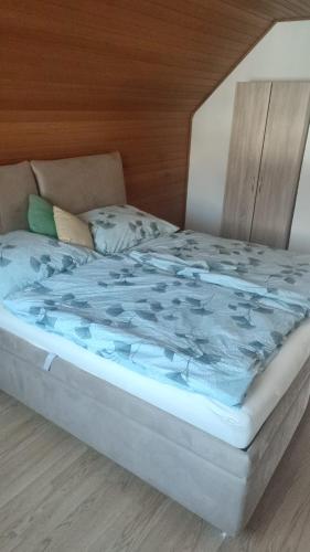 a bed with a blue blanket on top of it at Haus Jörgbauerngut in Spielberg
