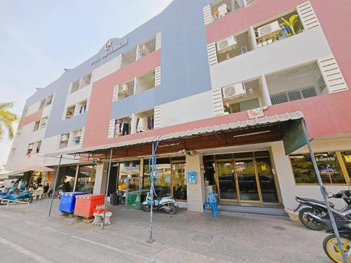 a large building with motorcycles parked in front of it at H-Hub BBT in Ban Khlong Yuan