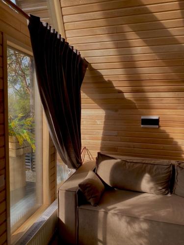a room with a bed and a window in a house at A-frame будиночок in Staraya Guta
