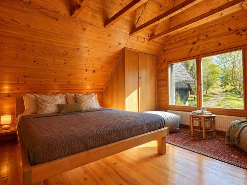 a bedroom with a bed in a wooden cabin at Soča Village in Soča
