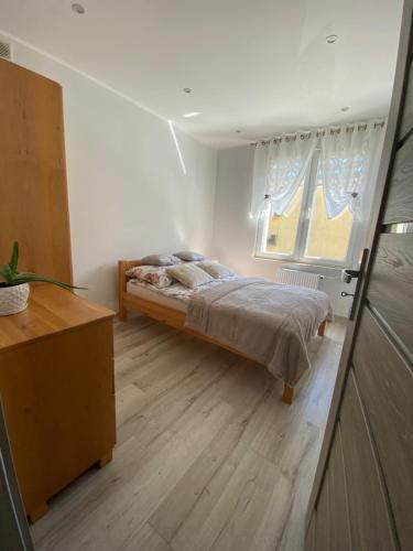 a bedroom with a bed and a window at Apartament DeLux WHITE Konin in Konin