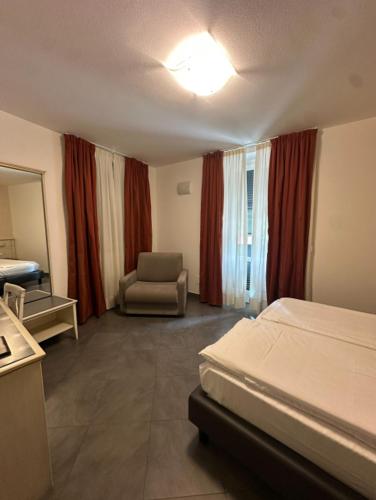 a hotel room with a bed and a chair at Hotel Margherita in Monterosso al Mare