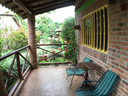 a patio with chairs and a table and a balcony at Cabañas La Carolina - Mesa de Los Santos in Los Santos