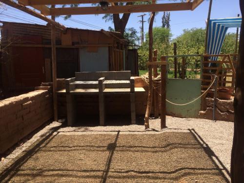 a childrens play area with a fence and a building at Refugio Don Natu in San Pedro de Atacama