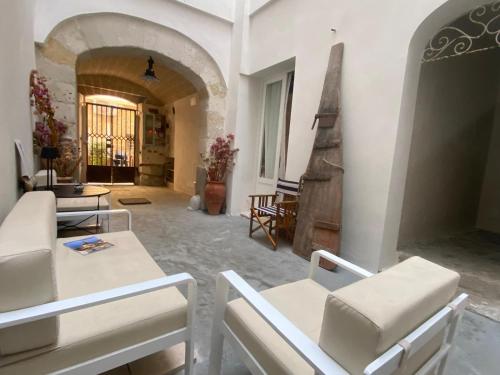 a living room with white chairs and a table at Cielomare Residence Diffuso in Trapani