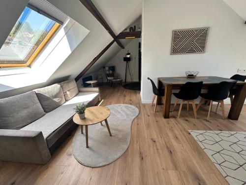 a living room with a couch and a table at Haus Lilium-Gemütliche Dachgeschoss Wohnung in Freudenstadt