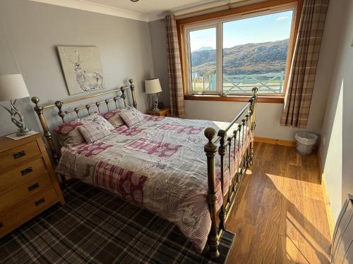 a bedroom with a bed and a large window at The Captains Achmelvich in Lochinver