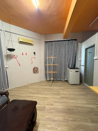 a living room with a table and a window at Baby Devil Studio 8 pax Homestay in Sibu