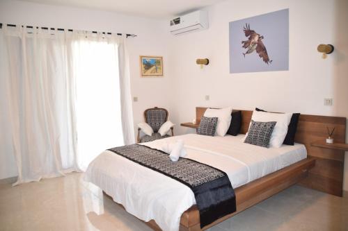 a bedroom with a large bed and a window at VillaRama in Saint-Louis