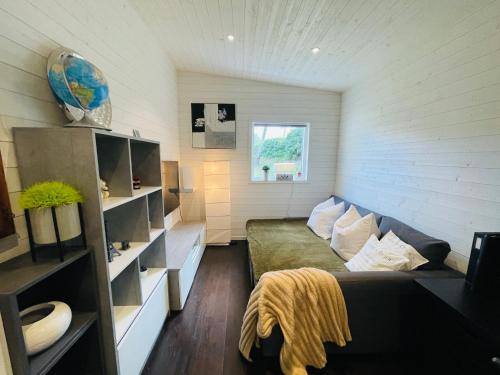 a living room with a couch in a room at 2 Modern guesthouses near The Beach in Falkenberg