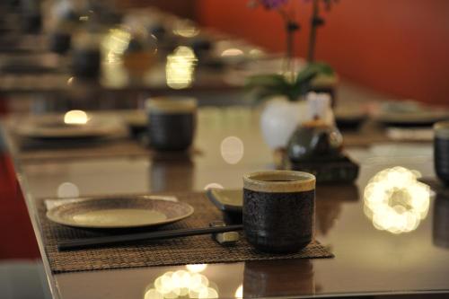 a table with a coffee cup and plates on it at Kaohsiung International Plaza in Kaohsiung