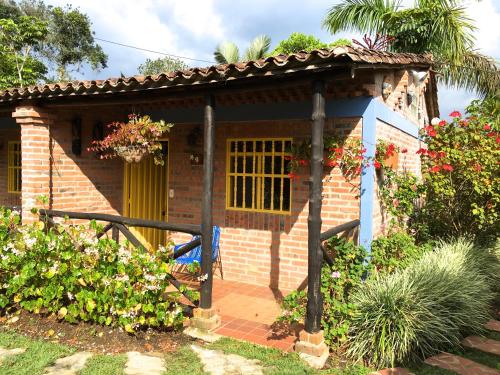 a small brick house with a yellow door at Cabañas La Carolina - Mesa de Los Santos in Los Santos