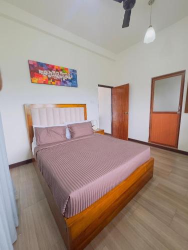 a bedroom with a large bed in a room at Lanthana Villa Kandy in Kandy