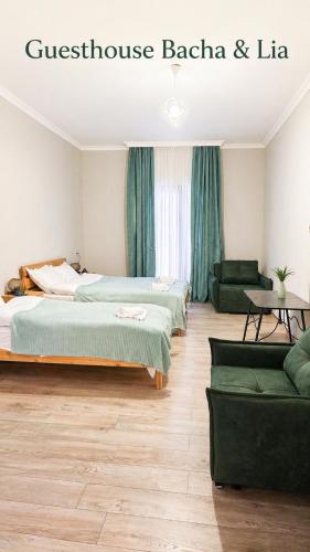 a hotel room with two beds and a couch at Guesthouse Bacha Lia in Mestia