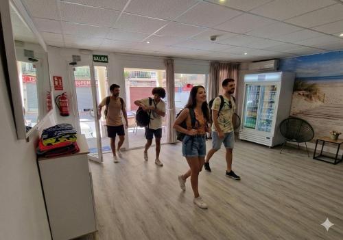 a group of people walking in a room at Hostal Sol de Mallorca in El Arenal
