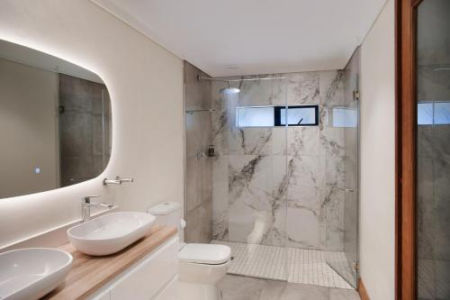 a bathroom with a shower and a toilet and a sink at Sani Mountain Escape in Mokhotlong