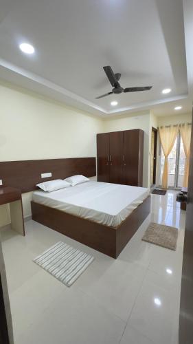 a bedroom with a large bed and a ceiling fan at Vilasa stays and colive in Hyderabad