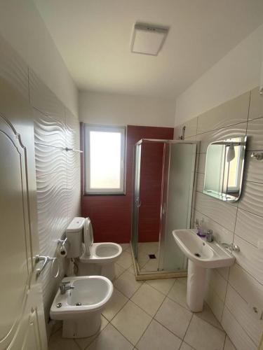 a bathroom with two sinks and a shower at Mare Nostrum Residence in Shëngjin