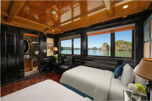 a bedroom with a bed and a view of the water at Overnight Cruise in Hai Phong