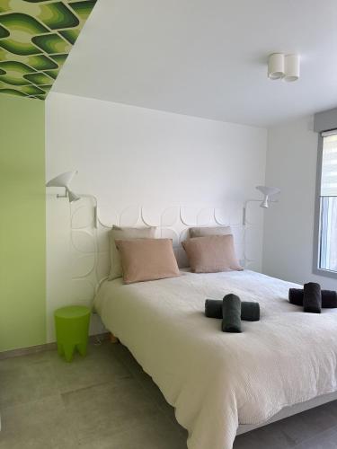 a bedroom with a large bed with two pillows at La Bergerie 2 in Neufchâteau