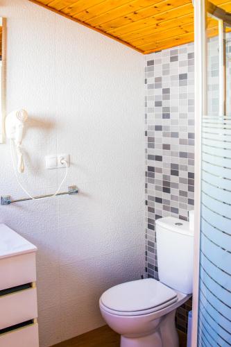 a bathroom with a toilet and a sink at Casa Corralazos in Castril