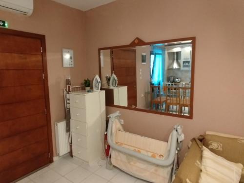 a hospital room with a mirror and a chair at Sunshine in Olympiada