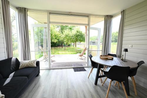 a living room with a couch and a table at Chalet Zijdewind in Zijdewind