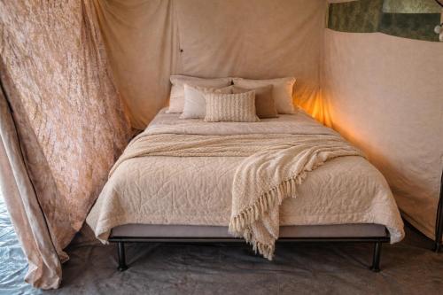 a bedroom with a bed in a tent at glamping bravatents in Blanes