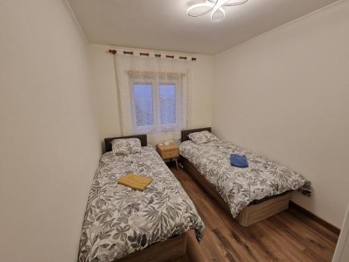 a bedroom with two beds and a window at Caparica City & Beach in Caparica