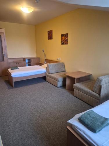 a hotel room with a bed and a couch at Hotel Na Jižní in Přerov