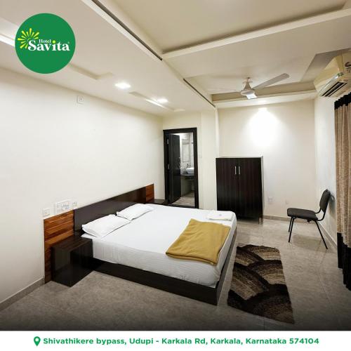 a bedroom with a bed and a chair in it at Hotel savita in Kārkāl